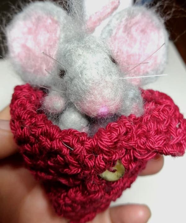 Grey mouse in a pocket