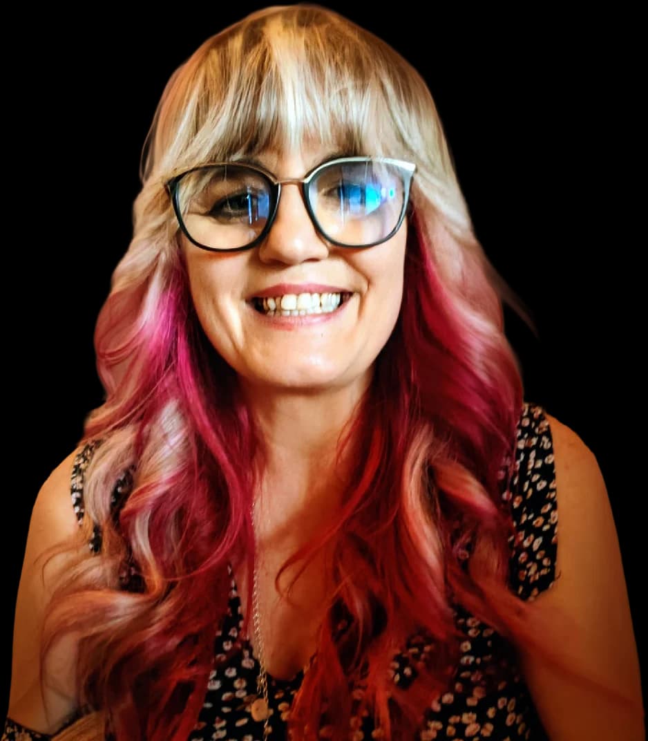 Lisa Snyman, Mrs. S, smiling, with glasses and long pink-tipped hair